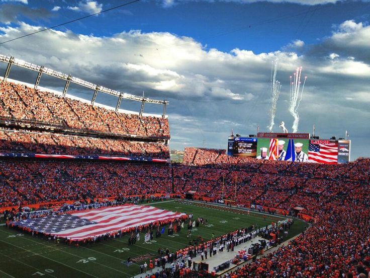 an orange and white football stadium filled with fans