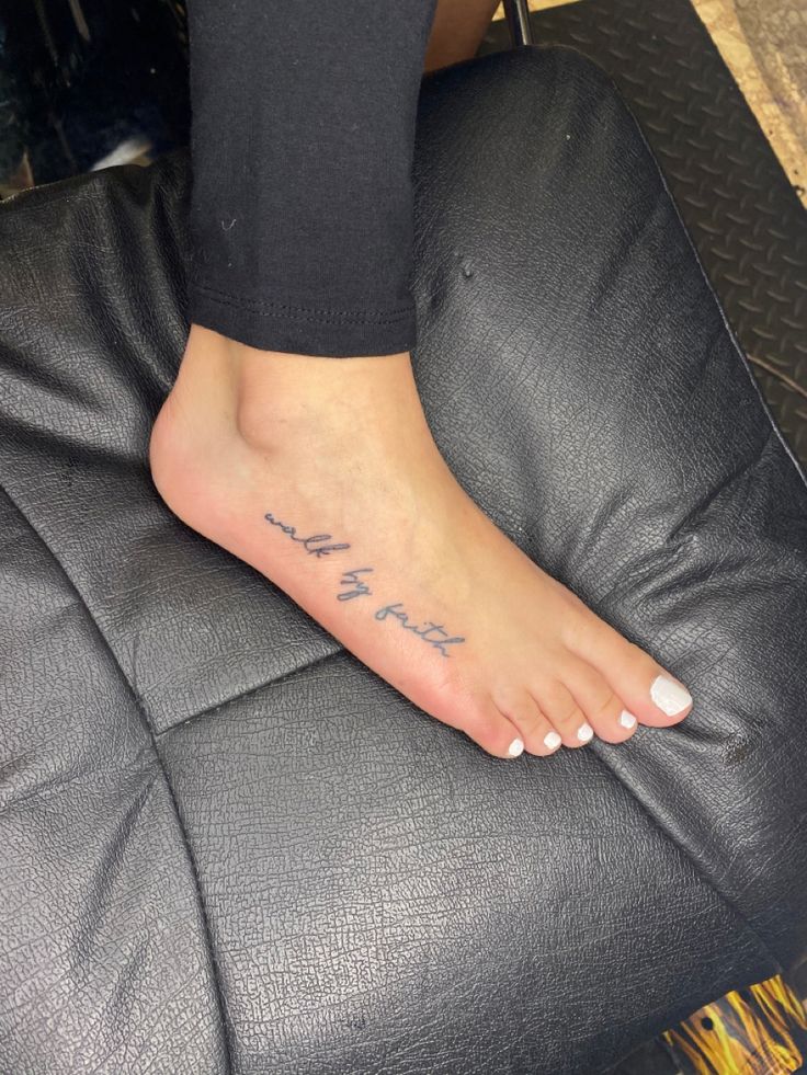 a woman's foot with writing on it