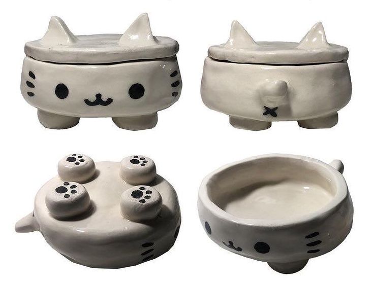 three ceramic bowls with cats on them and one bowl has two paws in the middle