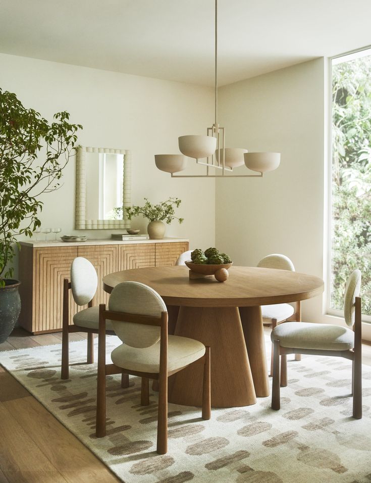 a dining room table with four chairs and a potted plant on top of it