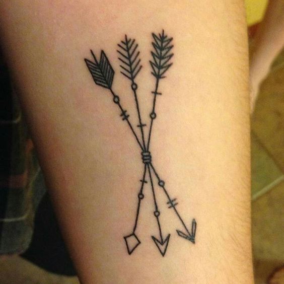 an arrow tattoo on the arm with arrows drawn across it's back side and sides