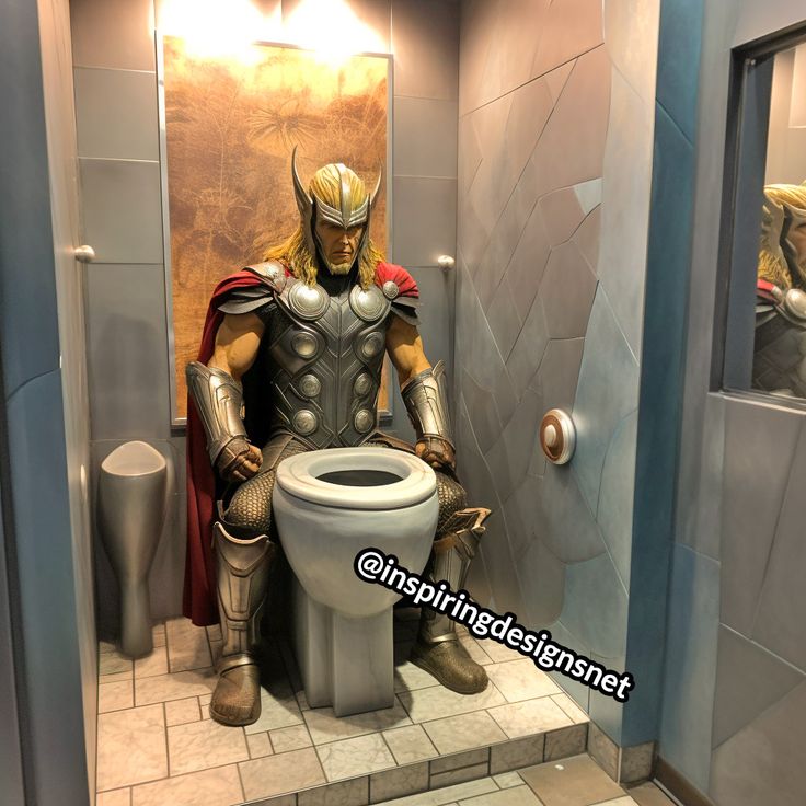 a man in armor is sitting on a toilet