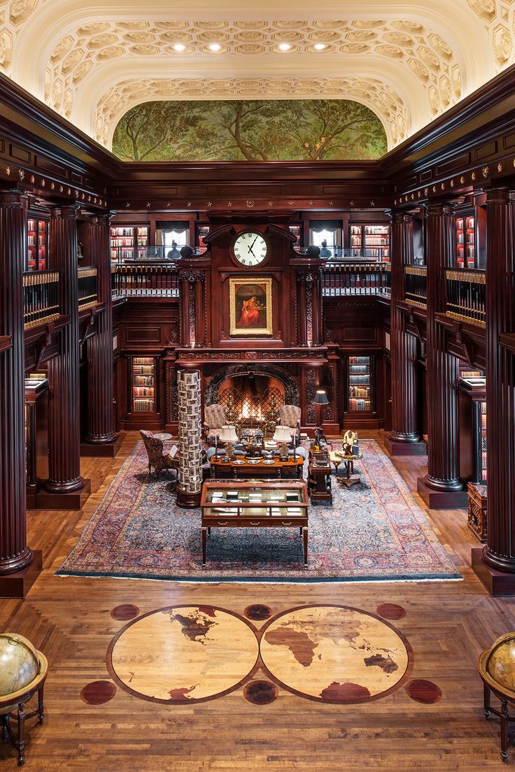 the inside of a library with many bookshelves and couches in it's center