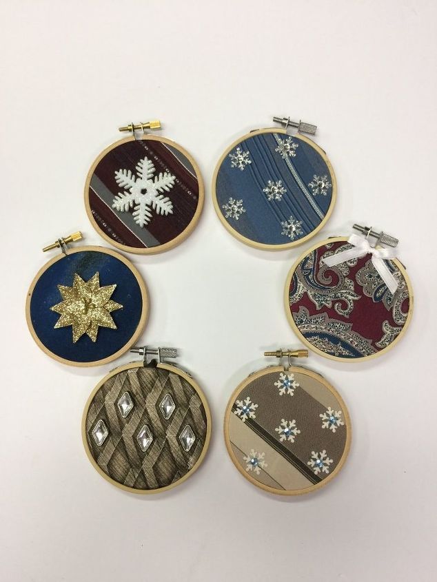 six different types of embroidery on wooden hoops with snowflakes in the middle