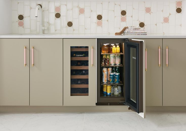 an open refrigerator in a kitchen next to a counter