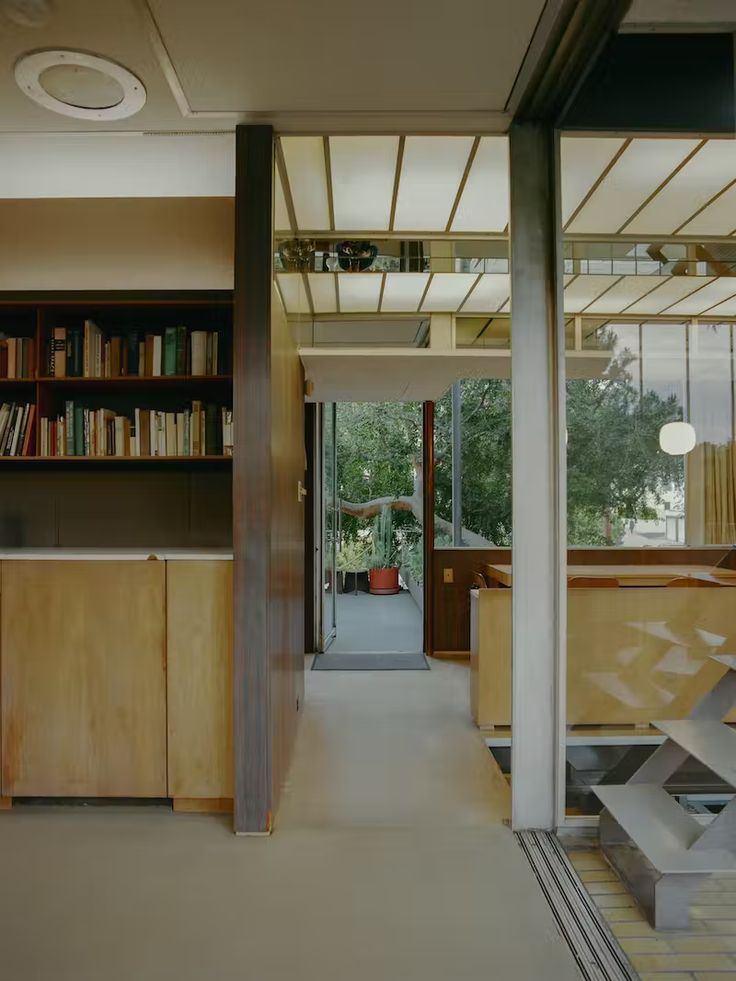 an open living room and dining area with bookshelves