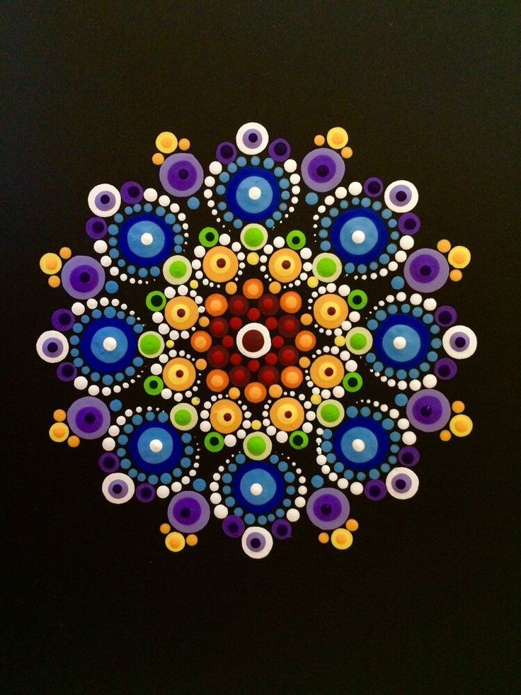 an image of a colorful flower made out of beads on a black background with circles and dots in the center