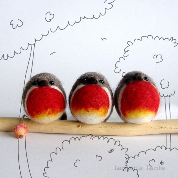 three little birds sitting on top of a wooden stick with red and yellow feathers,