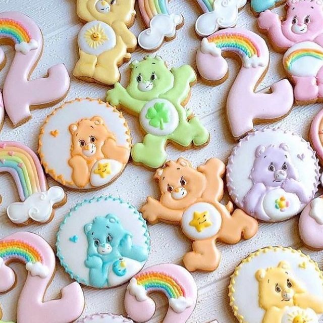 there are many decorated cookies with teddy bears and rainbows on them, all in different colors