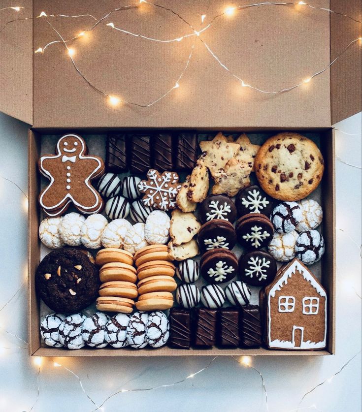 an open box filled with cookies, cookies and other treats on top of a table