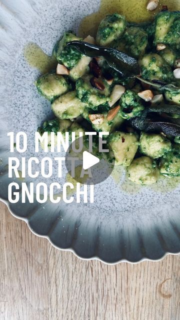 a bowl filled with broccoli and other vegetables on top of a wooden table