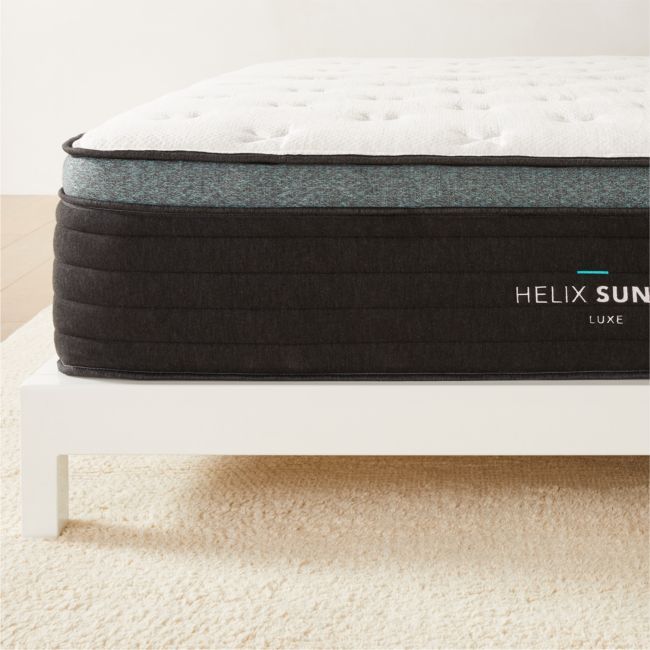 the helix sun mattress is on top of a white bed frame in a room