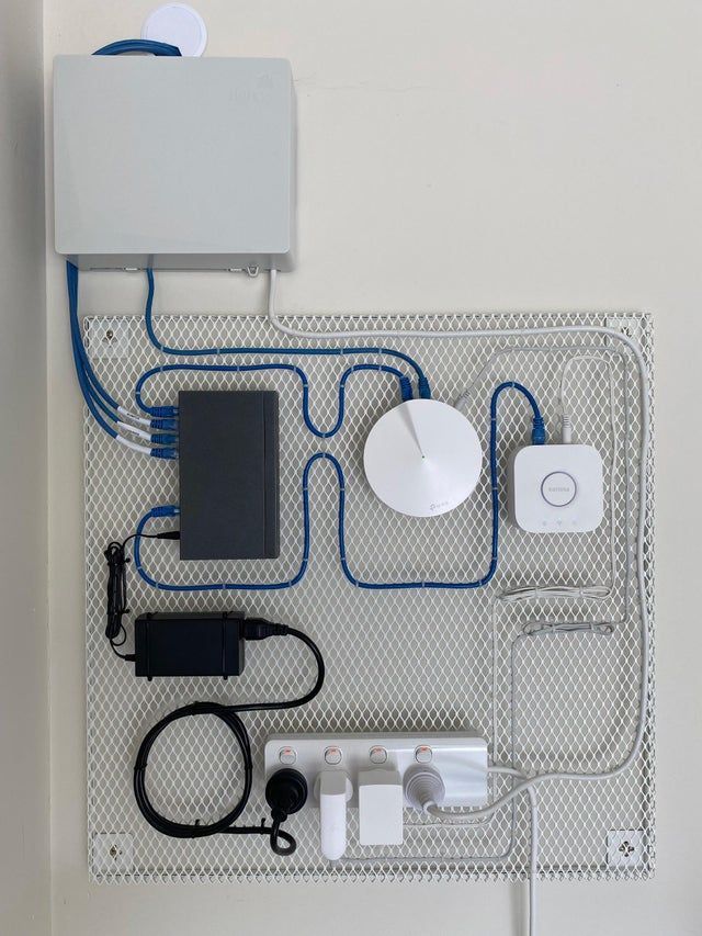 an electronic device connected to wires and plugs on a white board with blue piping