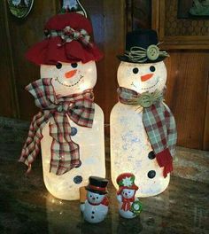 two snowmen are standing next to each other