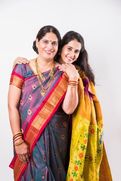 two women standing next to each other in sari