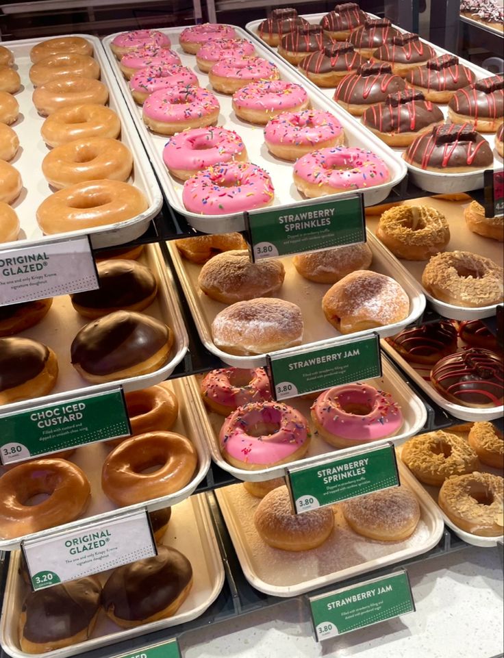 there are many different kinds of doughnuts on display