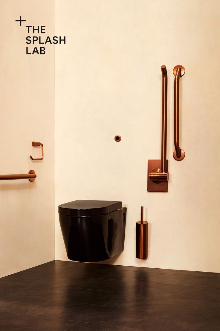 a black toilet sitting next to a wall mounted faucet in a room with white walls