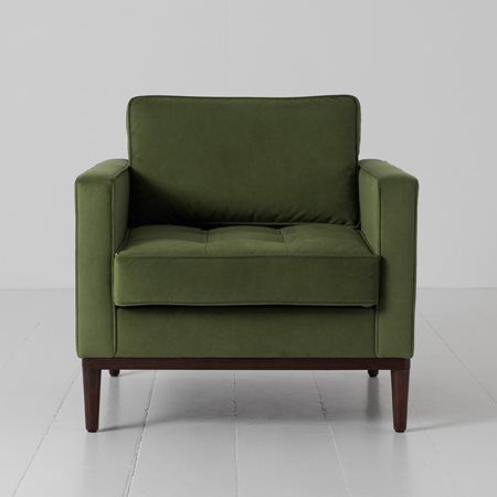 a green chair sitting on top of a white floor