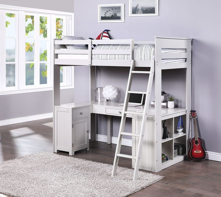 a white loft bed with stairs and desk in the corner next to a purple wall