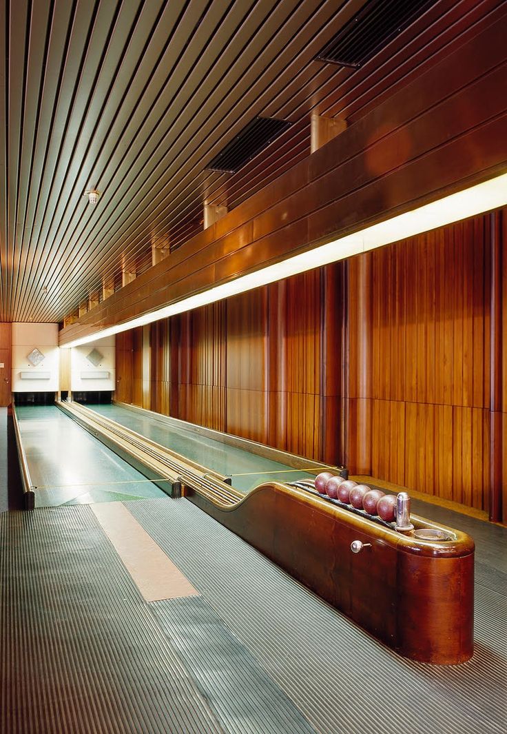 an empty luggage bag sitting on top of a conveyor belt in front of a wooden wall