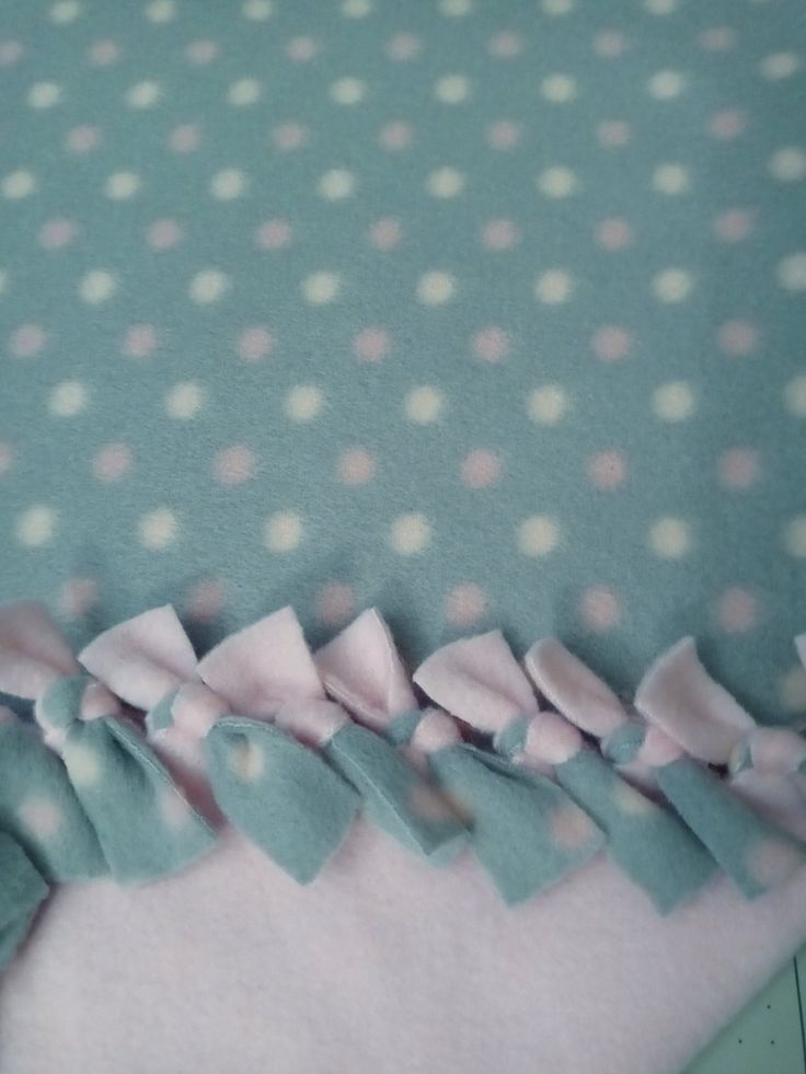 there is a blue and white polka dot fabric with pink bows on the bottom half