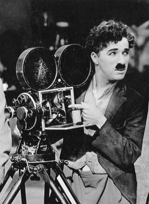 an old black and white photo of a man with mustaches looking at a camera