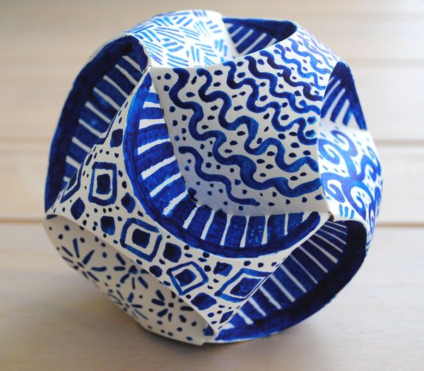 a blue and white vase sitting on top of a wooden table