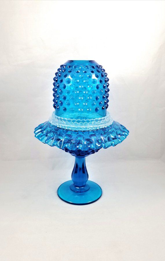 a blue glass cake dish on a white background