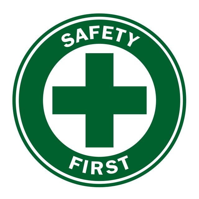 a green and white sign with the words safety first in it's center circle