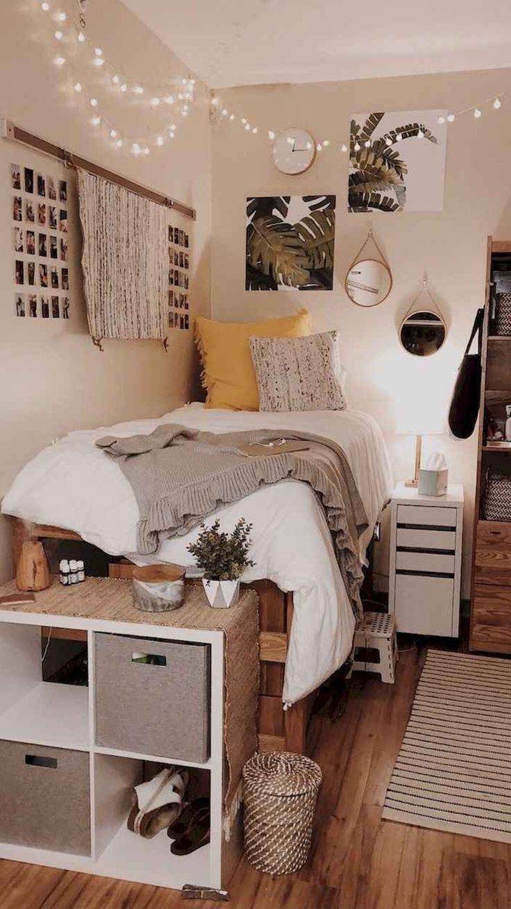 a bed room with a neatly made bed and lots of decorations on the wall above it