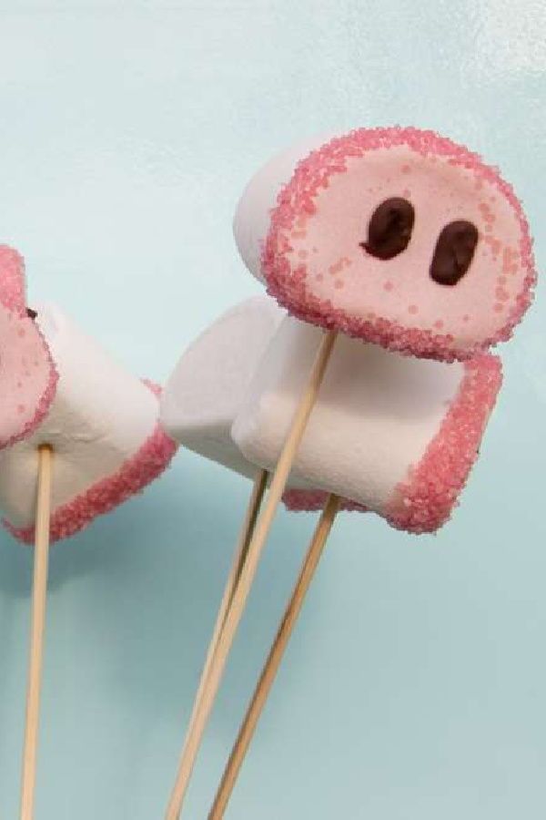 two marshmallows with faces on them sitting next to each other in front of a blue background