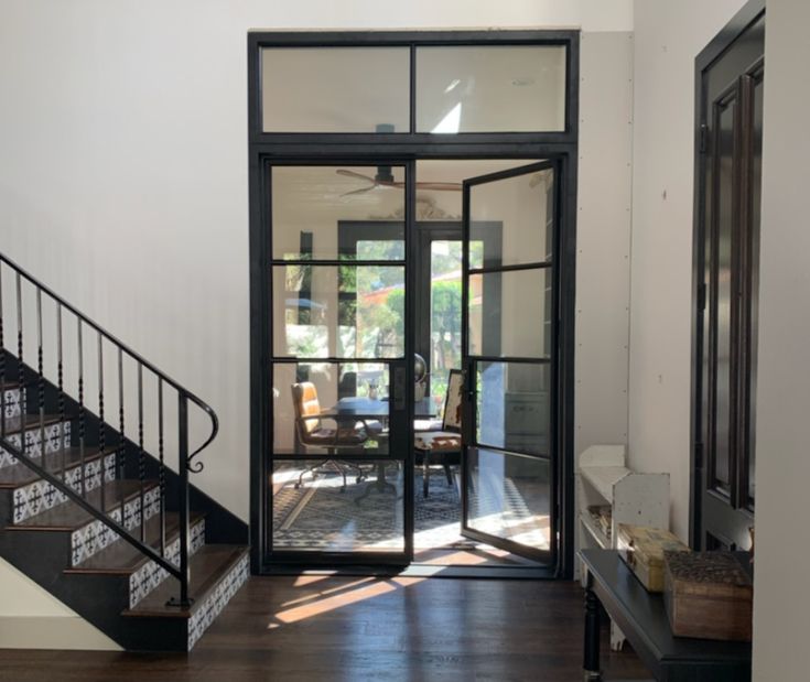 an open door leading to a living room and dining area