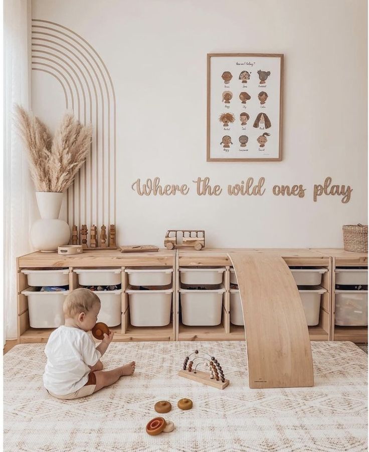 a baby sitting on the floor playing with toys in a playroom that says, where the wild ones play