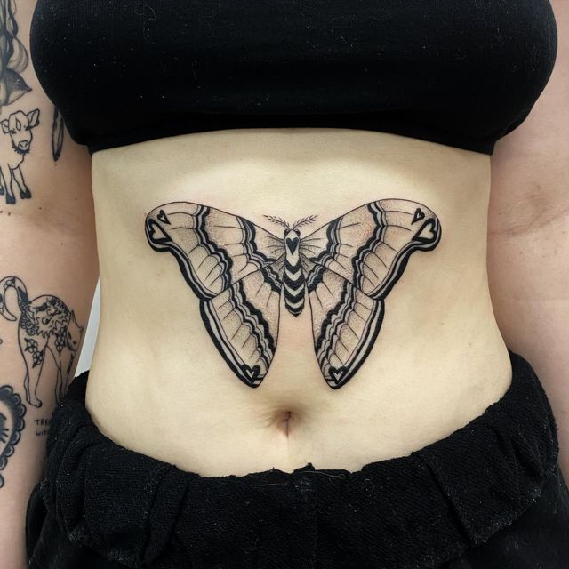 a woman's stomach with a butterfly tattoo on her lower body and bottom part