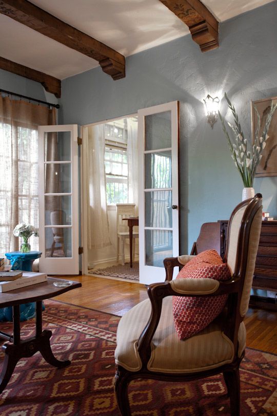 a living room filled with furniture and windows