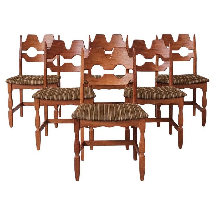 a set of six wooden chairs sitting next to each other