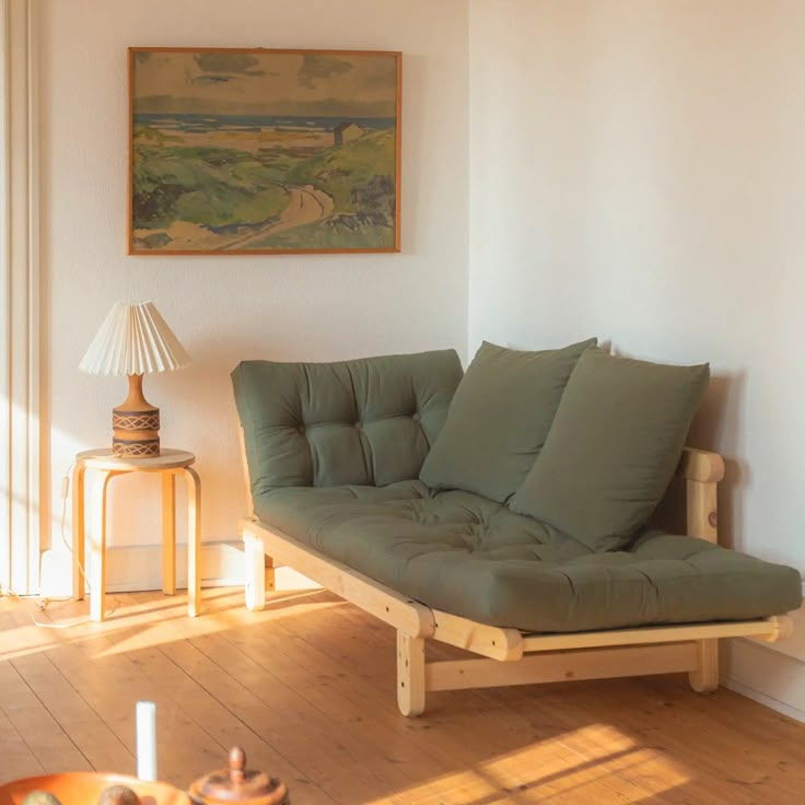 a living room with a futon couch and coffee table