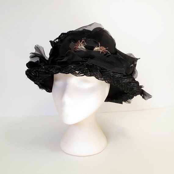 "Vintage 50's black picture hat made of braided cello straw, profusely decorated with black silk flowers and petals.  Flat-top crown and wire-edged brim.  Metal fastening comb on the inside band.  So chic and elegant.  No maker's label present.  S I Z I N G  printed sizenone fits like asmall circumference....20 1/2\" crown4\"  C O N D I T I O N  It appears there may be one flower missing at the very back.  MORE VINTAGE HATS  http://www.etsy.com/shop/JacquieVintage?section_id=6760142  BROWSE MY SHOP  http://etsy.com/shop/jacquievintage  CONNECT WITH ME  twitterjacquievintage facebookwww.facebook.com/JacquieVintage pinterestJacquie Vintage" Vintage Black Costume Hat With Curved Brim, Vintage Black Hat For Kentucky Derby, Black Vintage Cloche Hat With Curved Brim, Vintage Black Cloche Hat With Curved Brim, Vintage Black Wide Brim Costume Hat, Black Brimmed Hat For Vintage Events, Vintage Black Hat For Spring, Vintage Black Hat For Evening, Vintage Black Cloche Hat For Evening