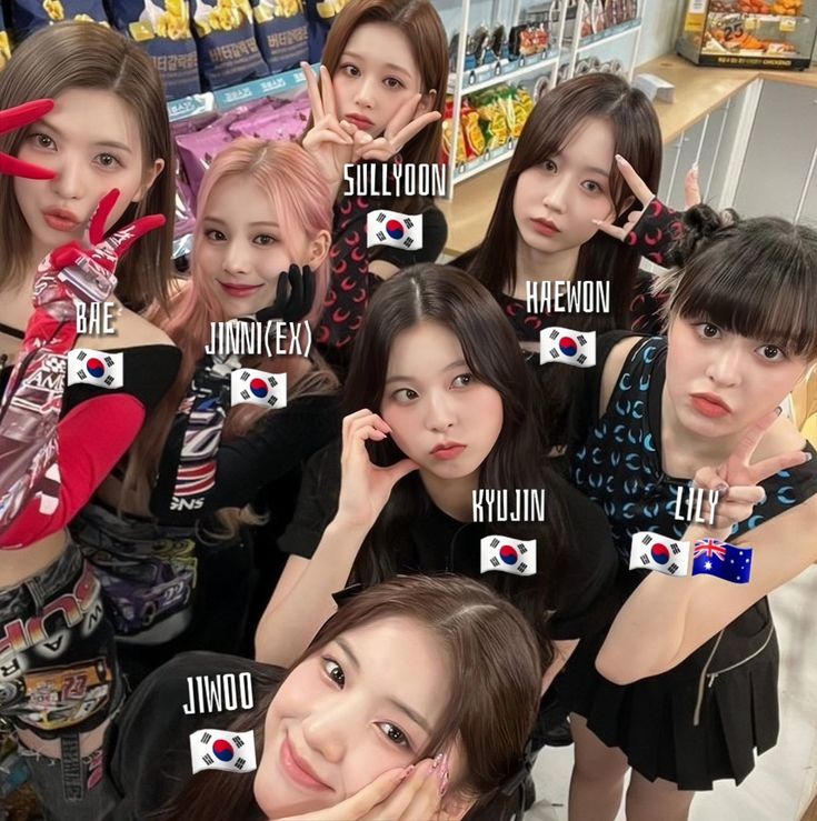 the girls are posing together in front of some shelves with their name tags on them