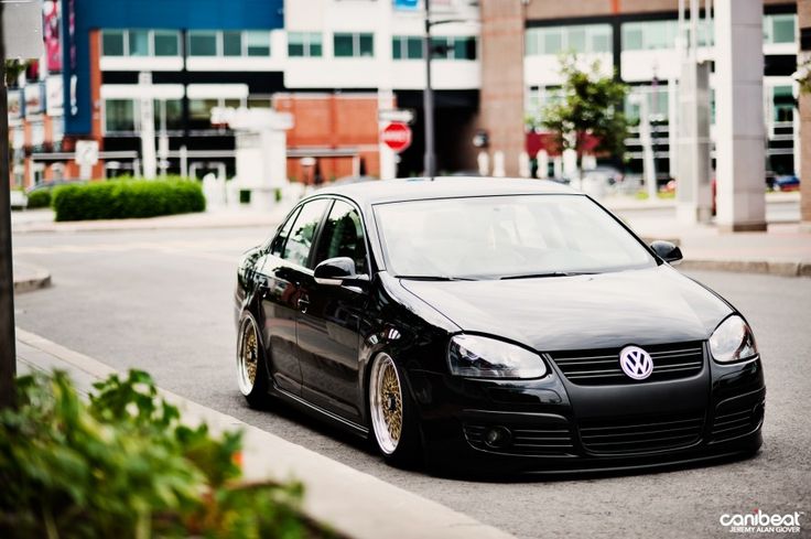 a black car is parked on the street