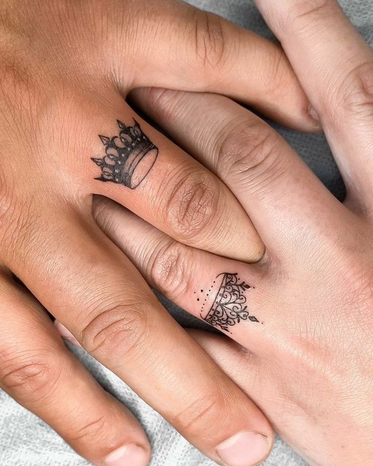 two people with matching tattoos on their fingers