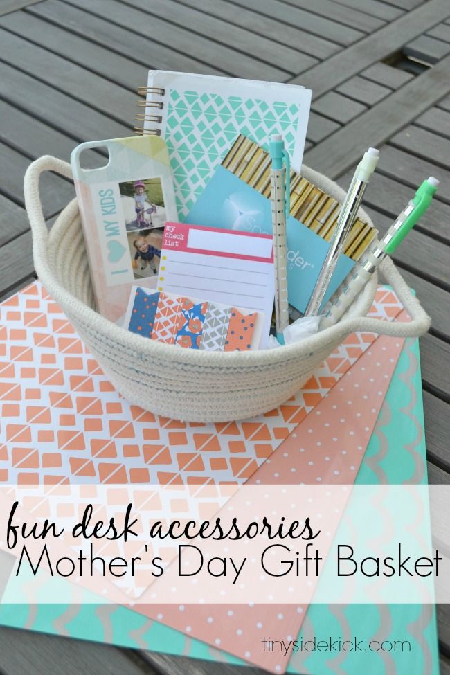 a basket filled with lots of different items on top of a wooden table next to a notepad