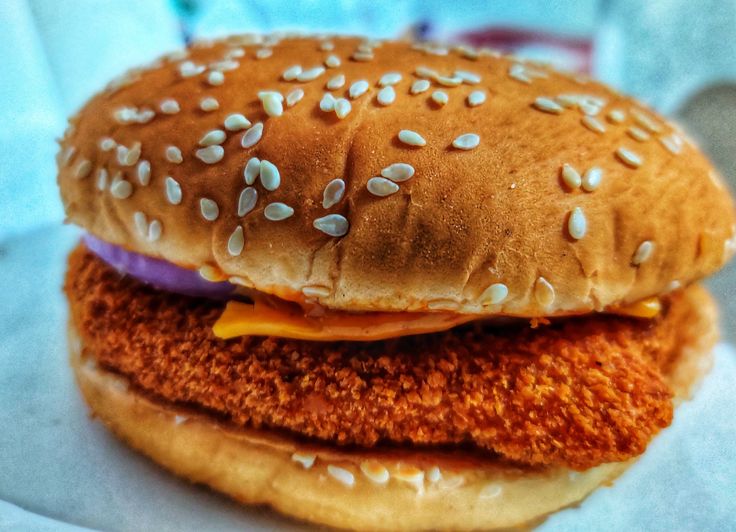 a close up of a sandwich with sesame seeds on it