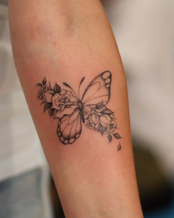 a woman's arm with a butterfly tattoo on it