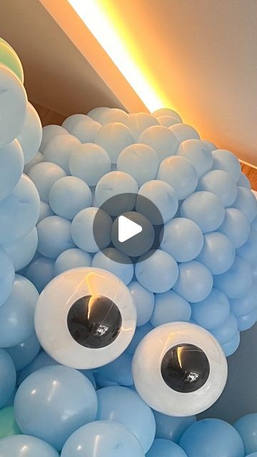 a bunch of balloons that are in the shape of an eyeball with eyes on them