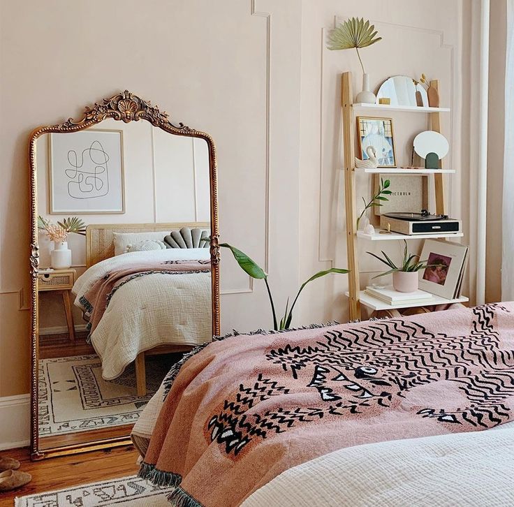 a bed room with a mirror and a neatly made bed