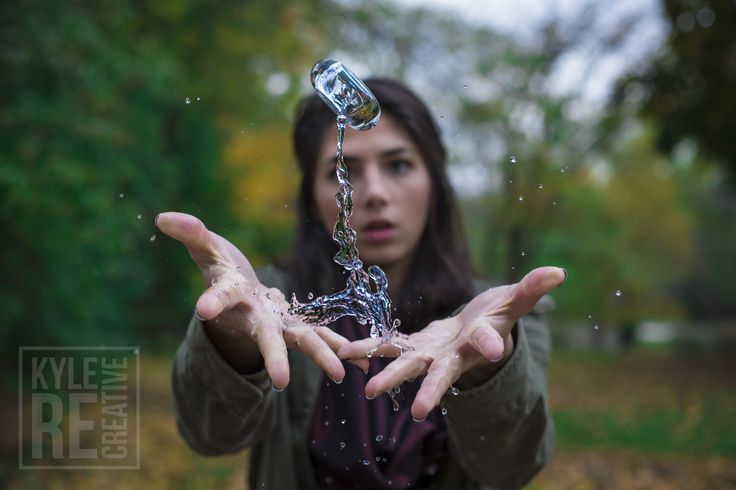 a woman is holding out her hands with water pouring from the faucet in front of her