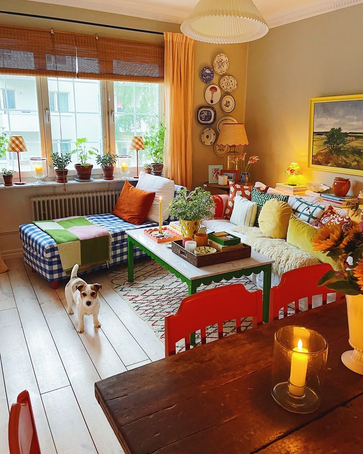 a living room filled with furniture and a dog standing in front of the couches