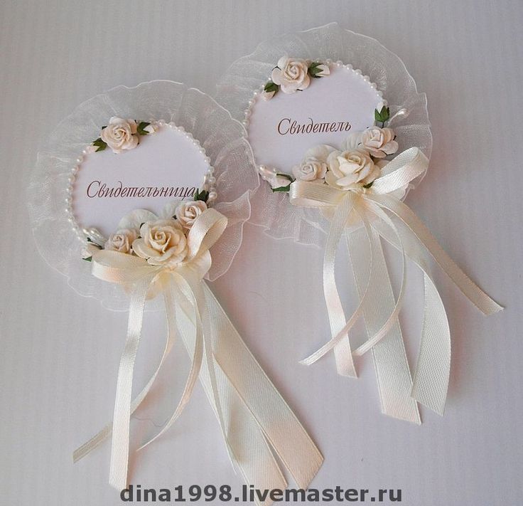 two wedding favors with ribbons and flowers on the top one is for someone to put their names on