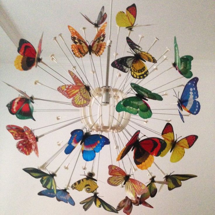 a chandelier with many colorful butterflies hanging from it